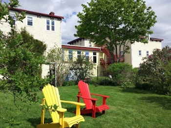 Der Garten des Anwesens, mit Liegestühlen im Vordergrund